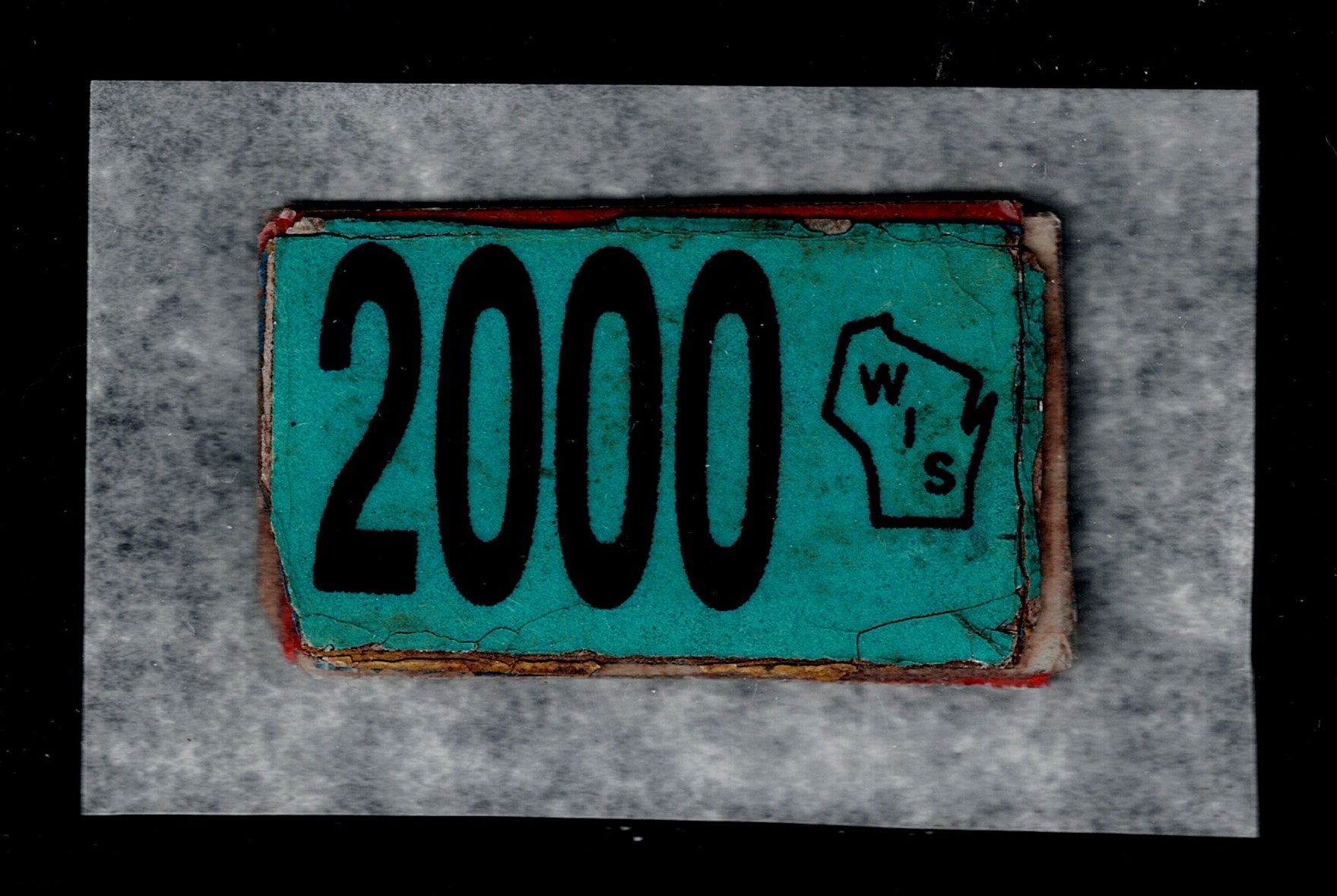 WI license plate tag U F 2000 tag on top of several prior years